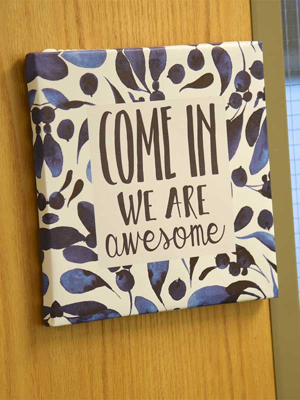 Door with sign with the words "Come in, we are awesome."