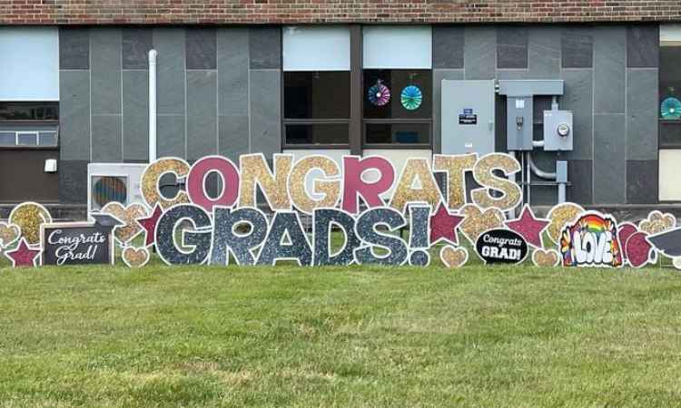 Lawns sign in front of Ben Bronz Academy school spelling Congrats Grads!