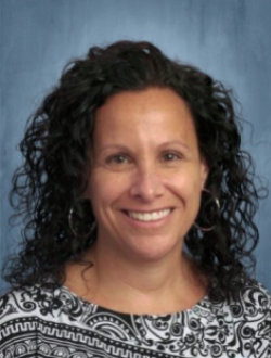 Curly haired smiling woman.