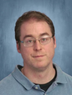 Male teacher, wearing glasses.