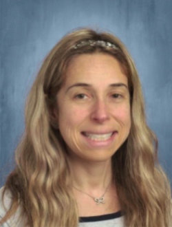Smiling female teacher with long blond hair.